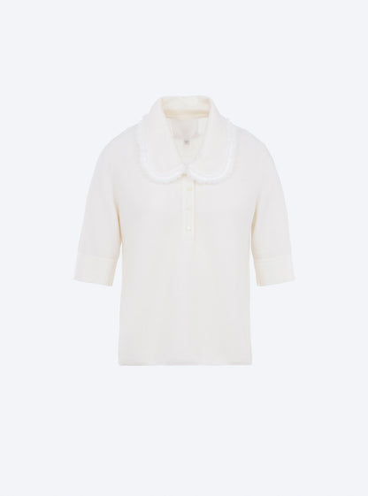 top en maille à col frangé