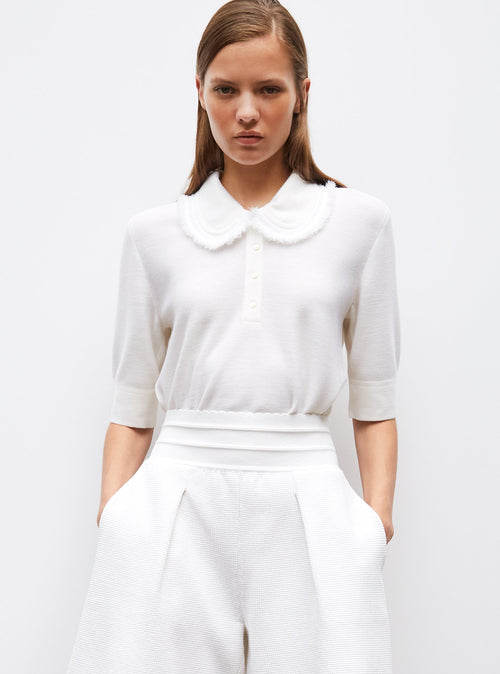 top en maille à col frangé